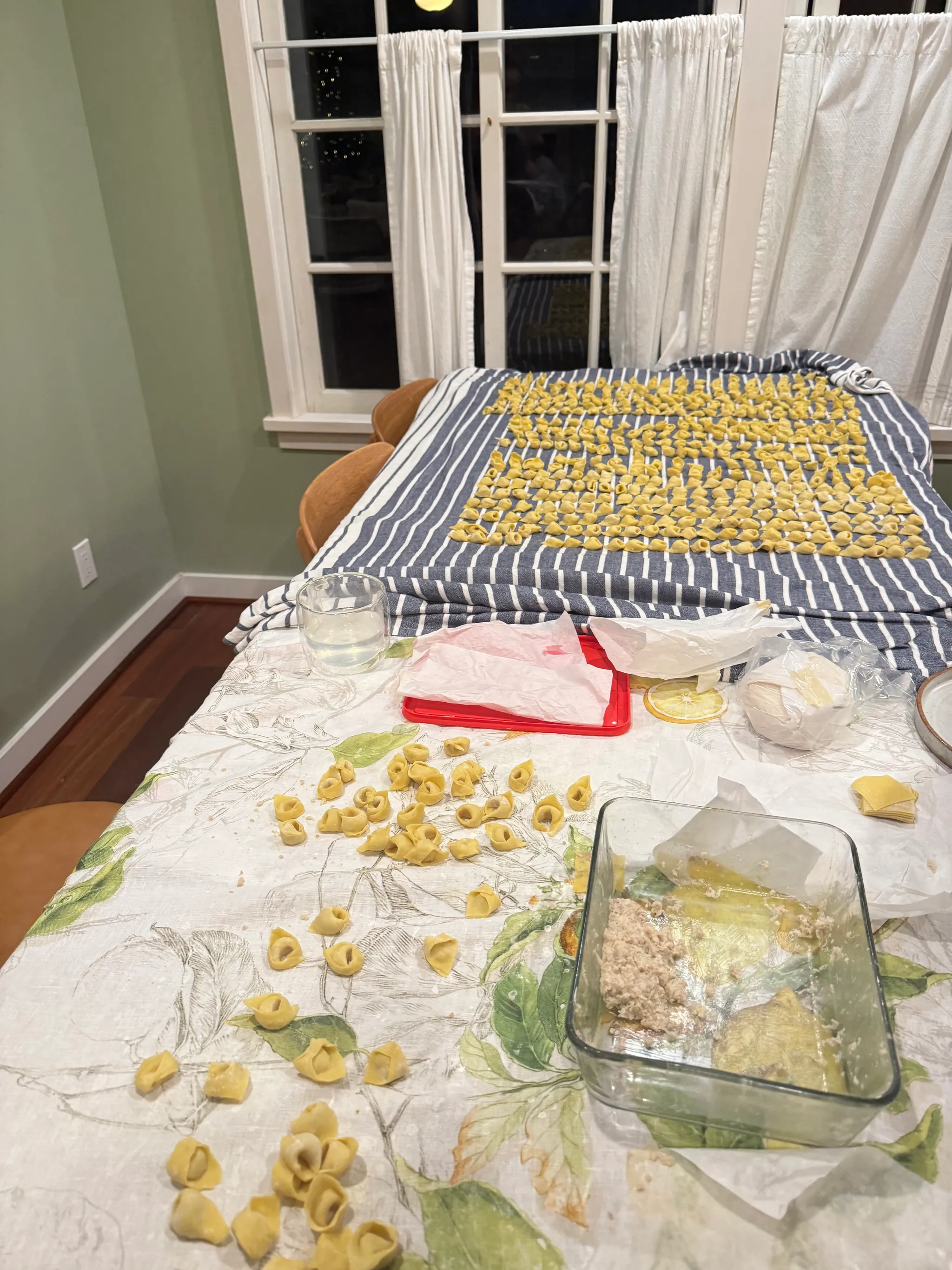 Hundreds of handmade tortellini drying on a table